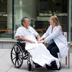 Doctor Attending to Patient in a Wheelchair